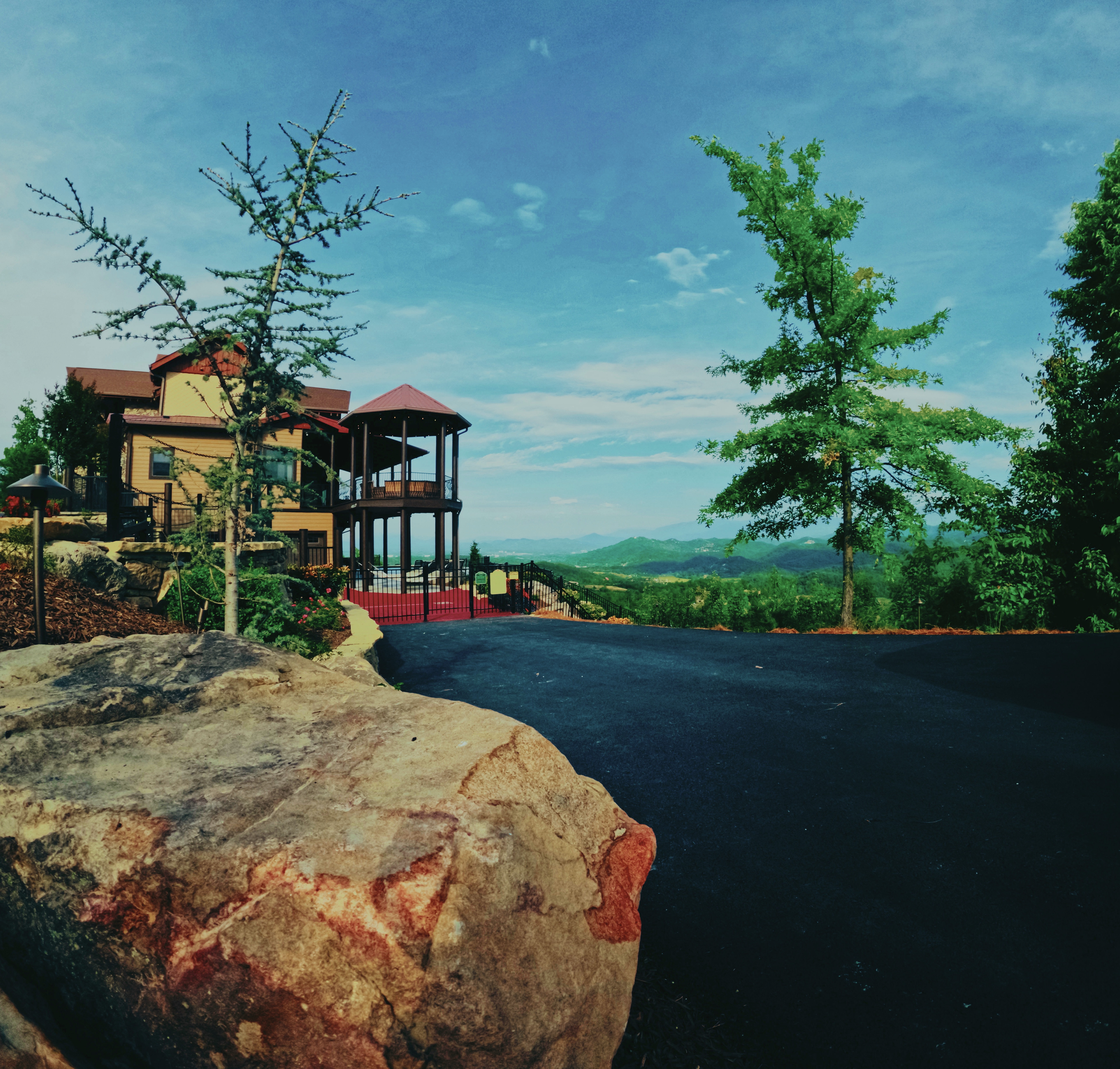 New arrival drive and planted landscape framing a mountain retreat.