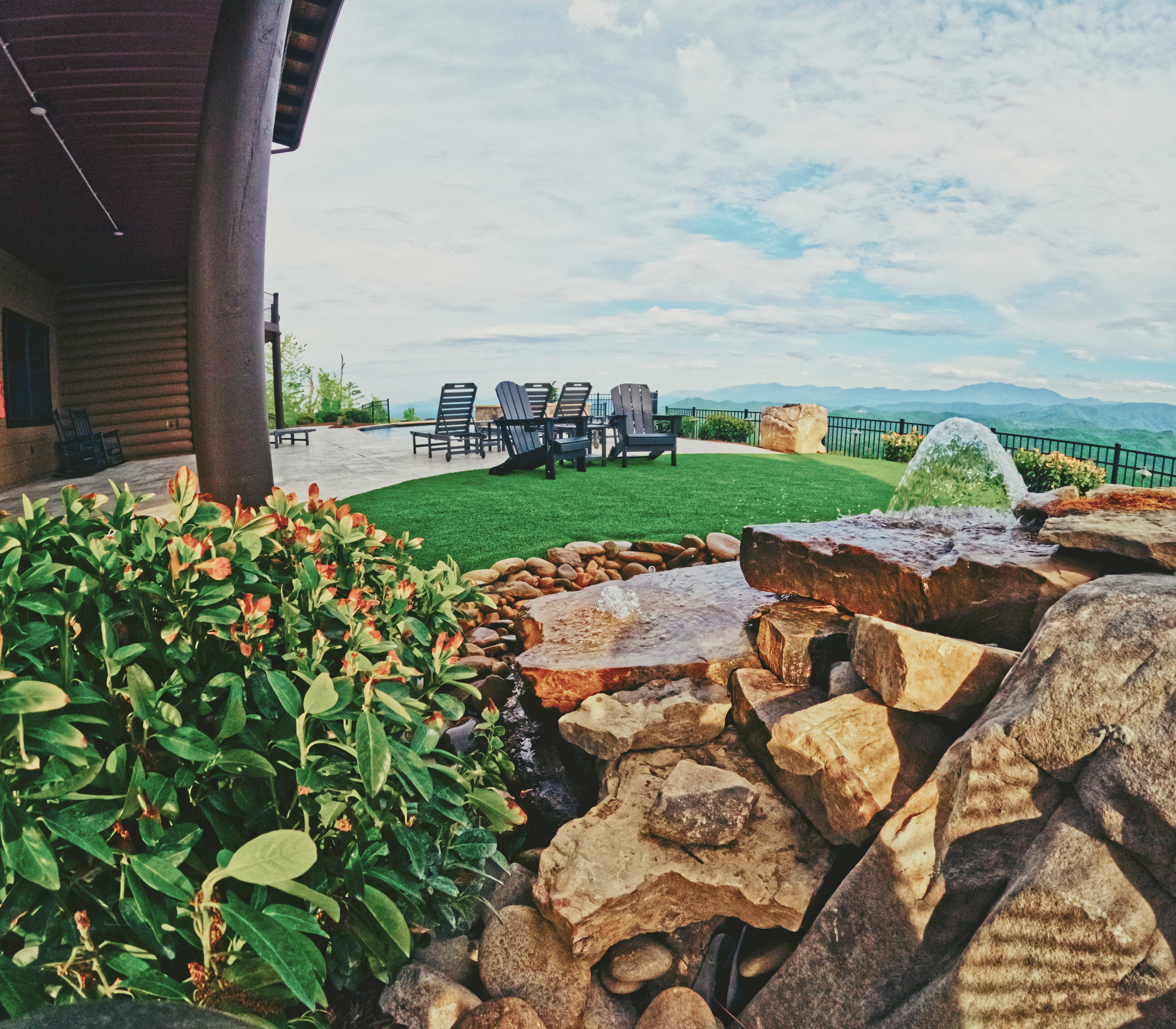 Custom water feature and lounge area overlooking the mountains.