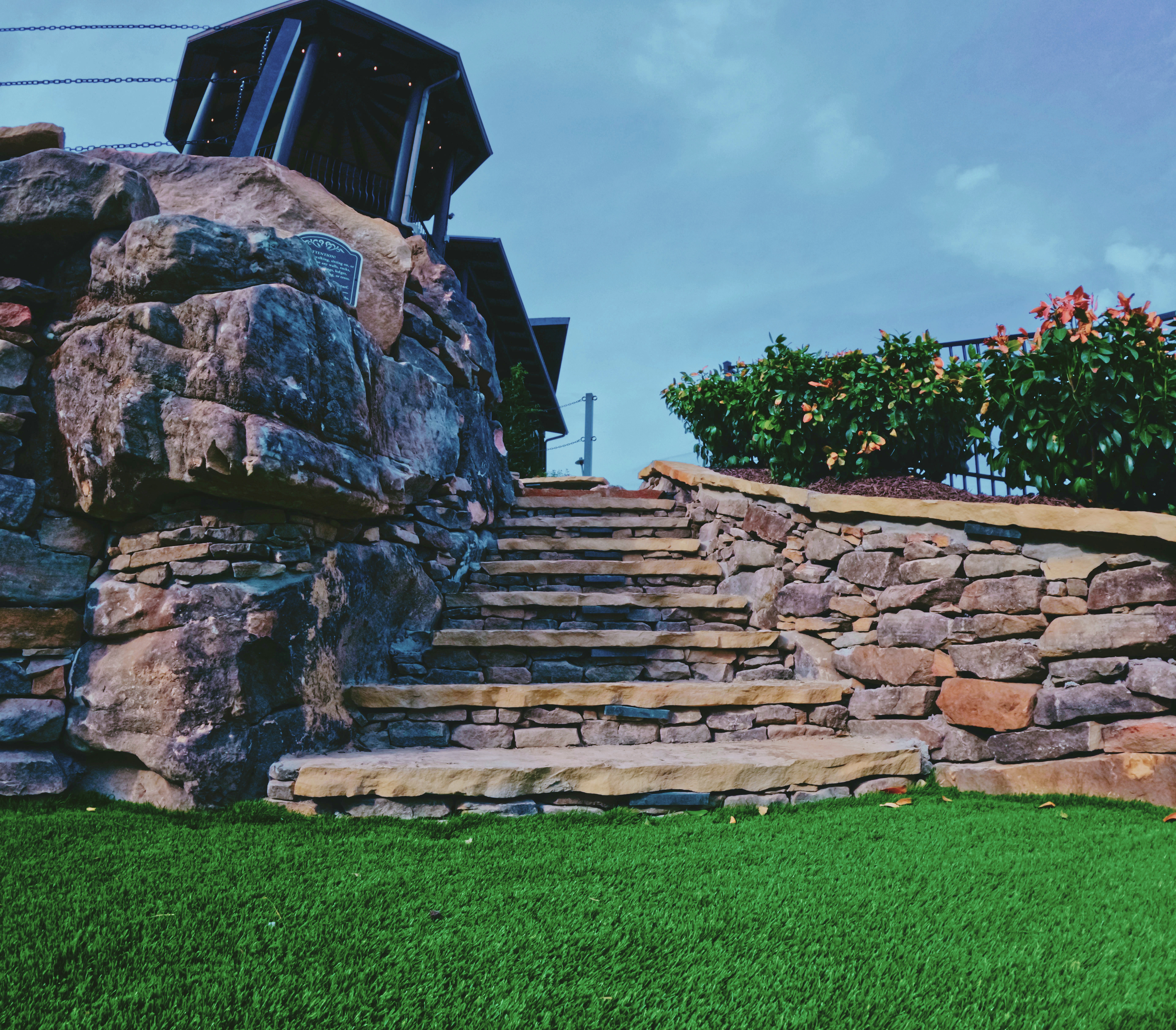 Handcrafted natural stone staircase and retaining wall detail.
