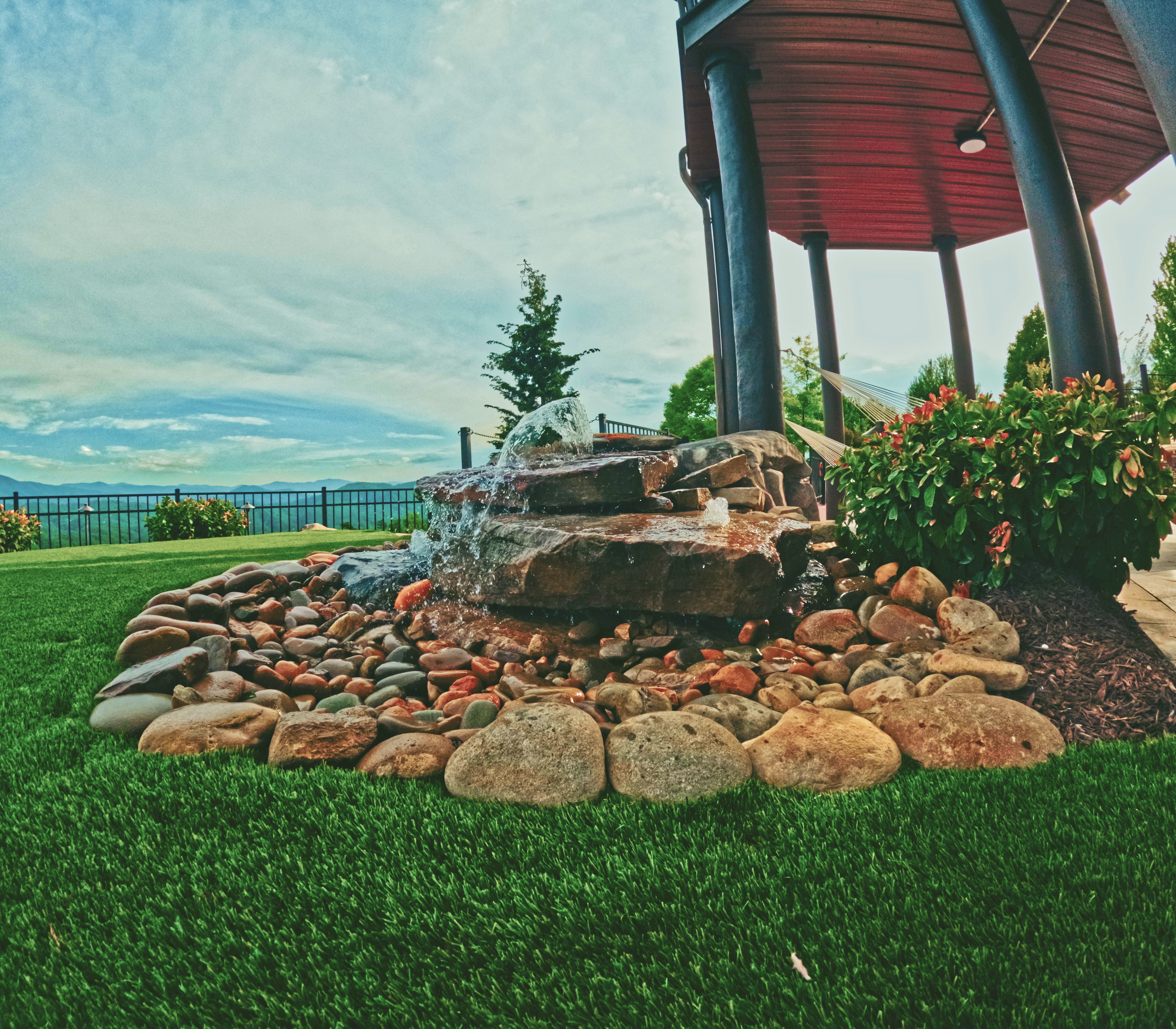 Tiered stone cascade water feature integrated into the landscape.