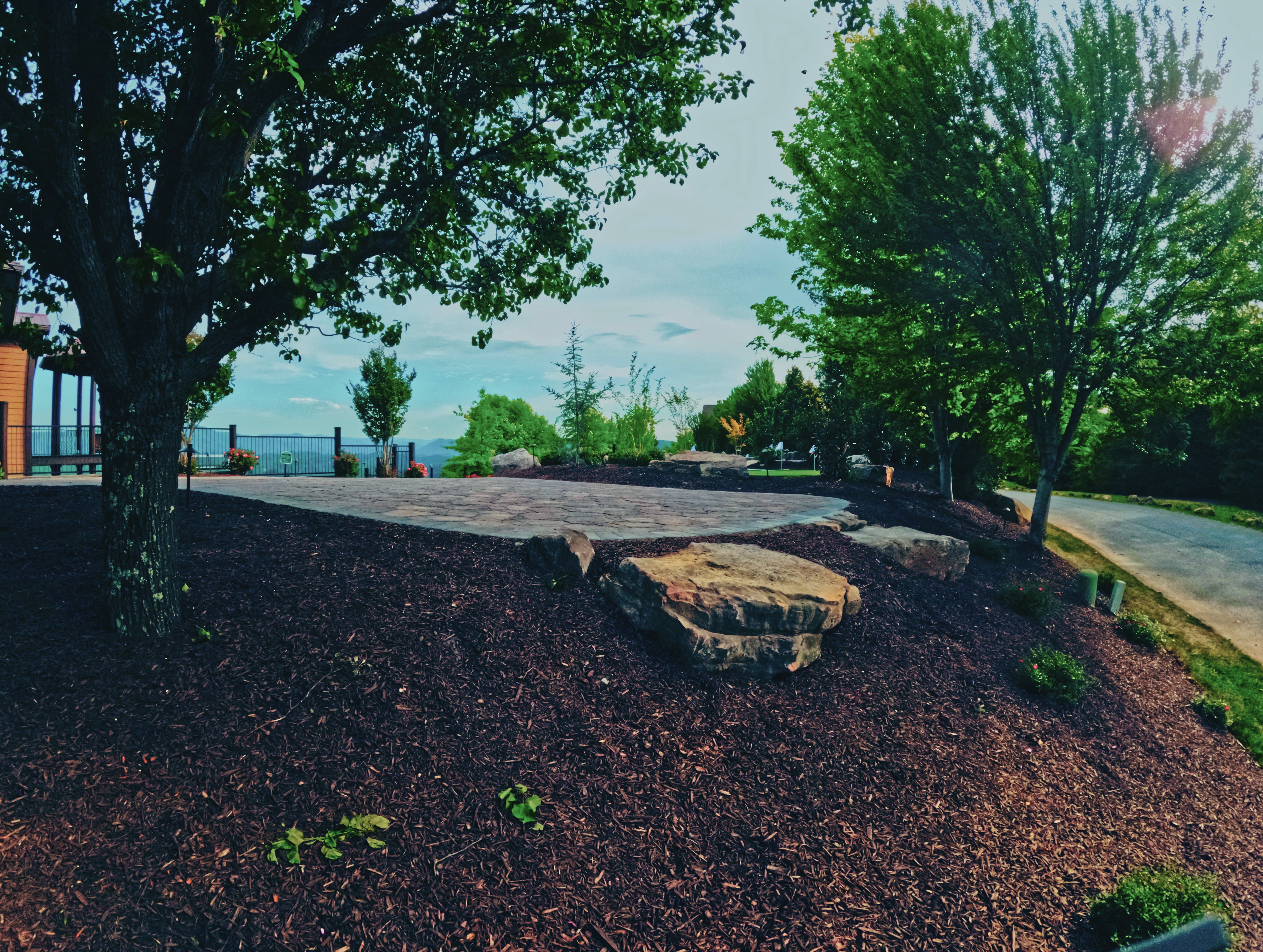 Custom stone patio and layered landscape planting at the retreat.